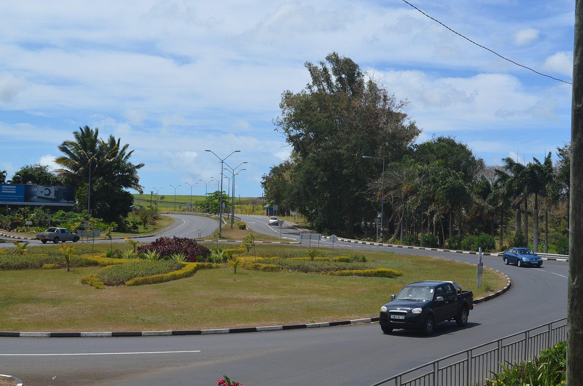 Cars driving on the left around a landscaped roundabout on the M2 road near Pamplemousses, Mauritius