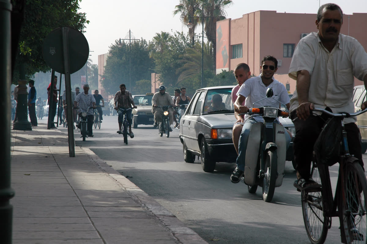 Cars, motorcycles and bicycles sharing a street in Marrakech