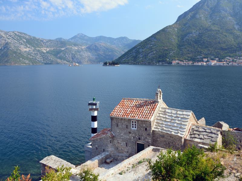 Stone chapel with a lighthouse above the Bay of Kotor, Montenegro